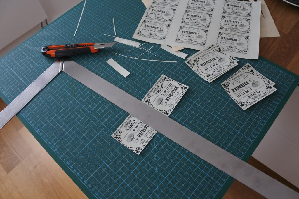 Cutting labels with a cutting knife and a steel ruler.